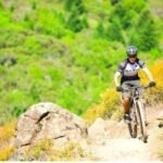 cyclist riding through the mountains